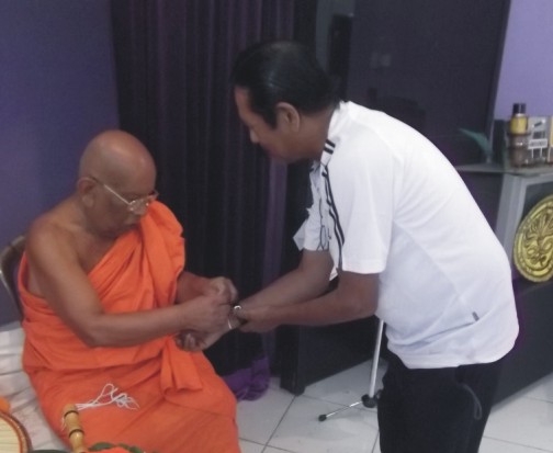 Tying of the pirith thread